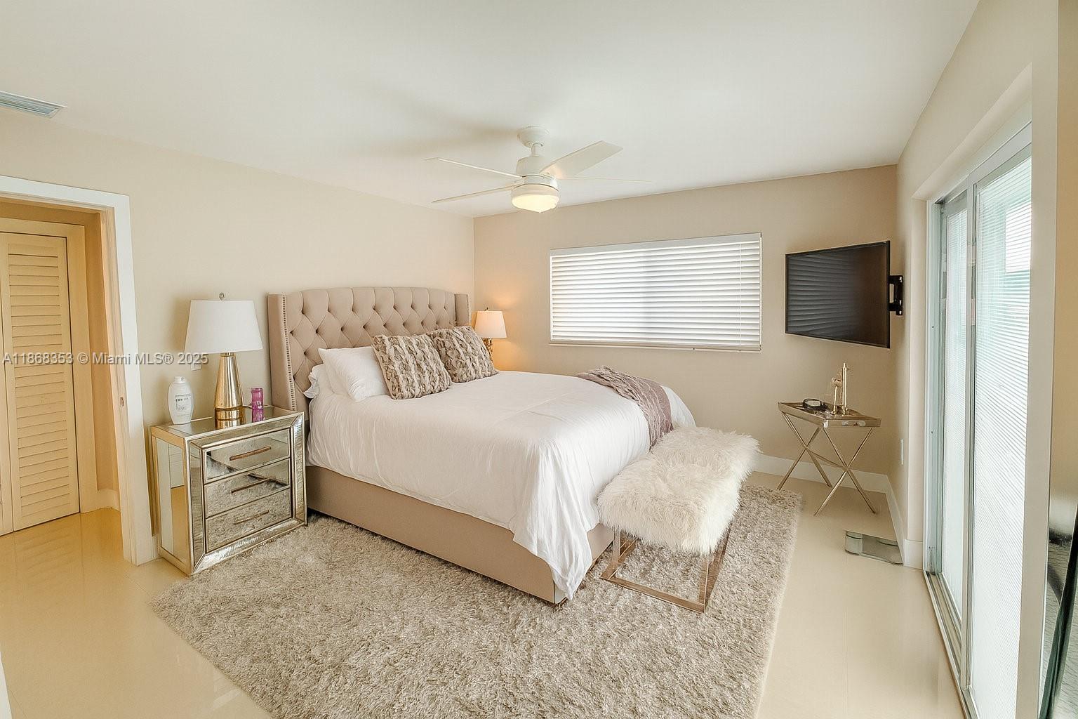 5250 Southwest 96th Avenue Miami, FL 33165 - Photo 12 of 16 a bedroom with a bed and a flat screen tv