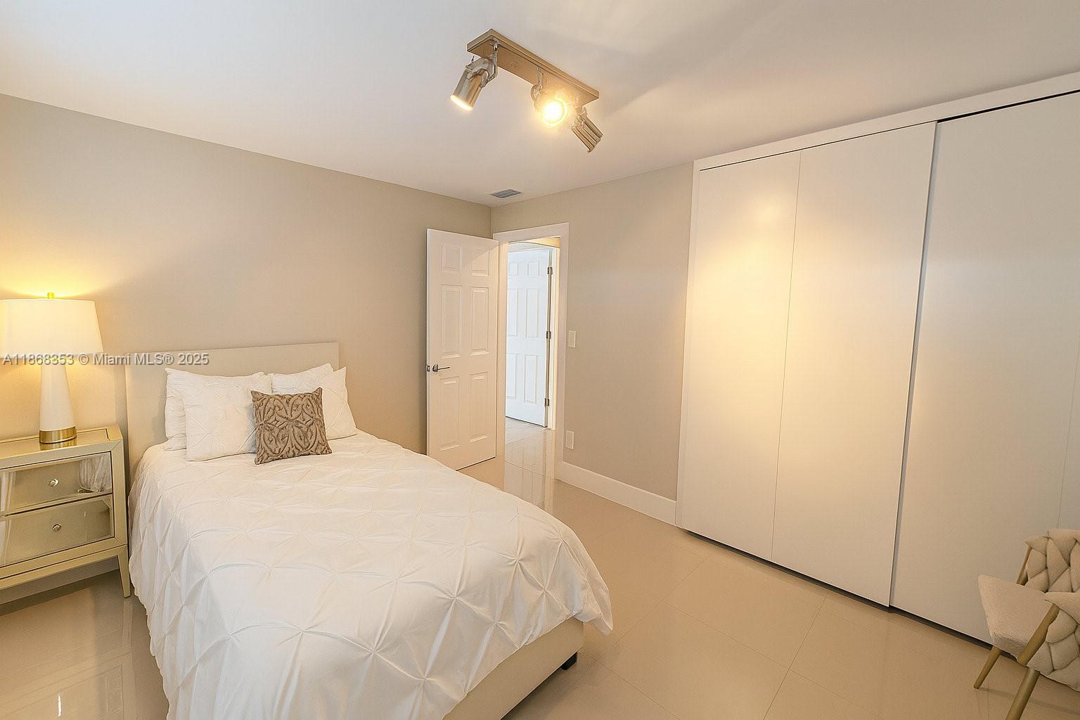 5250 Southwest 96th Avenue Miami, FL 33165 - Photo 13 of 16 a bedroom with a bed and a lamp