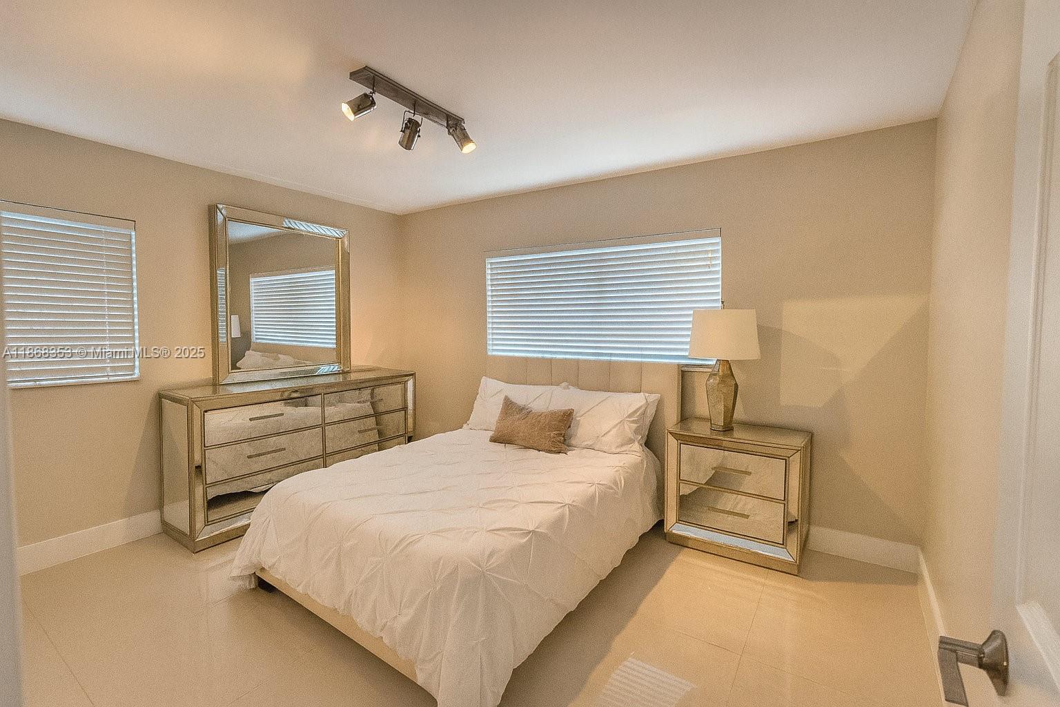 5250 Southwest 96th Avenue Miami, FL 33165 - Photo 14 of 16 a bedroom with a bed and wooden floor