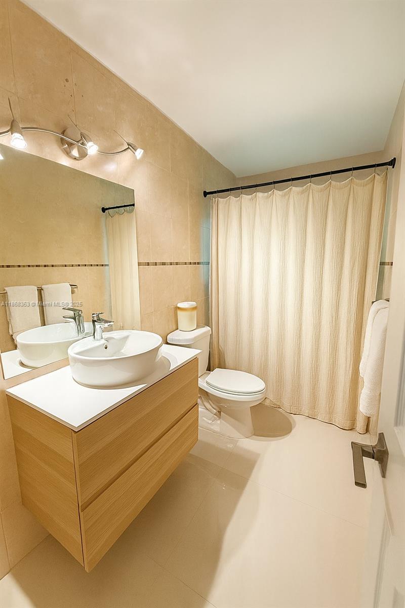 5250 Southwest 96th Avenue Miami, FL 33165 - Photo 16 of 16 a bathroom with a sink a toilet and shower