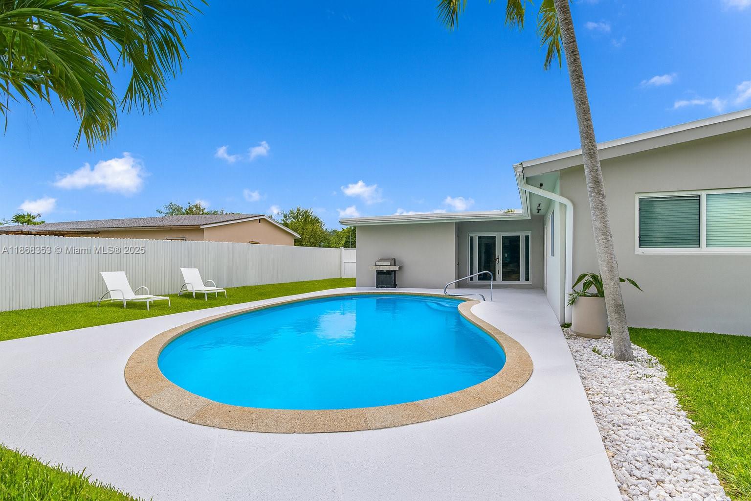 5250 Southwest 96th Avenue Miami, FL 33165 - Photo 3 of 16 a view of a swimming pool with a patio