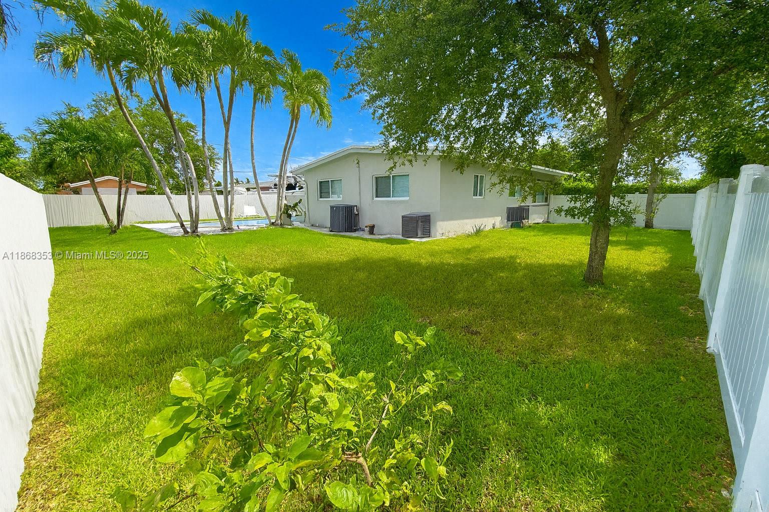 5250 Southwest 96th Avenue Miami, FL 33165 - Photo 4 of 16 a view of a backyard with a plants and palm trees