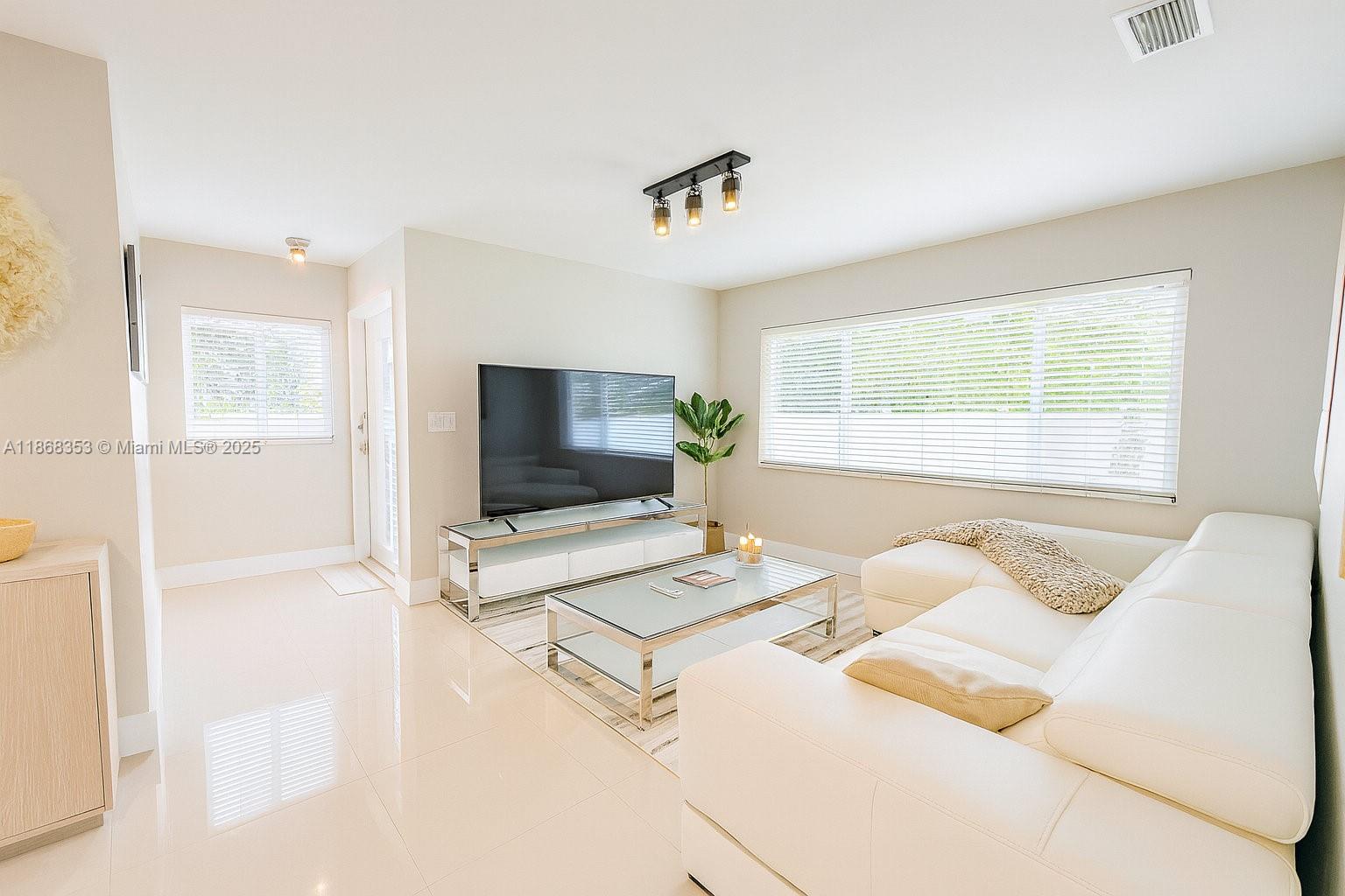 5250 Southwest 96th Avenue Miami, FL 33165 - Photo 6 of 16 a living room with furniture and a flat screen tv
