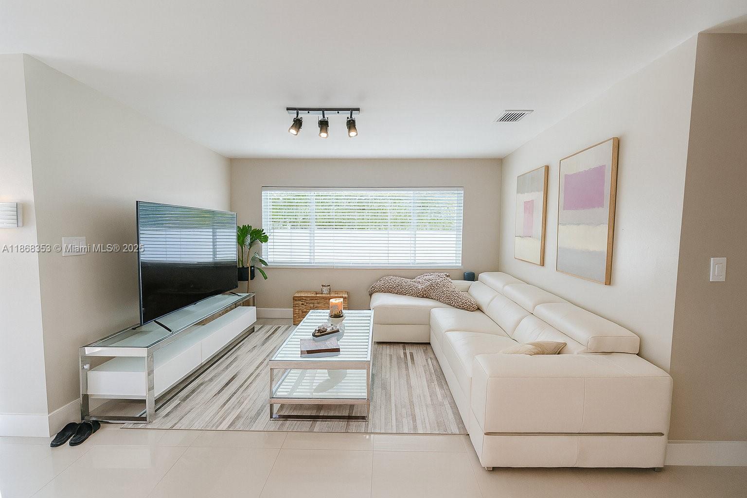 5250 Southwest 96th Avenue Miami, FL 33165 - Photo 7 of 16 a living room with furniture and a flat screen tv