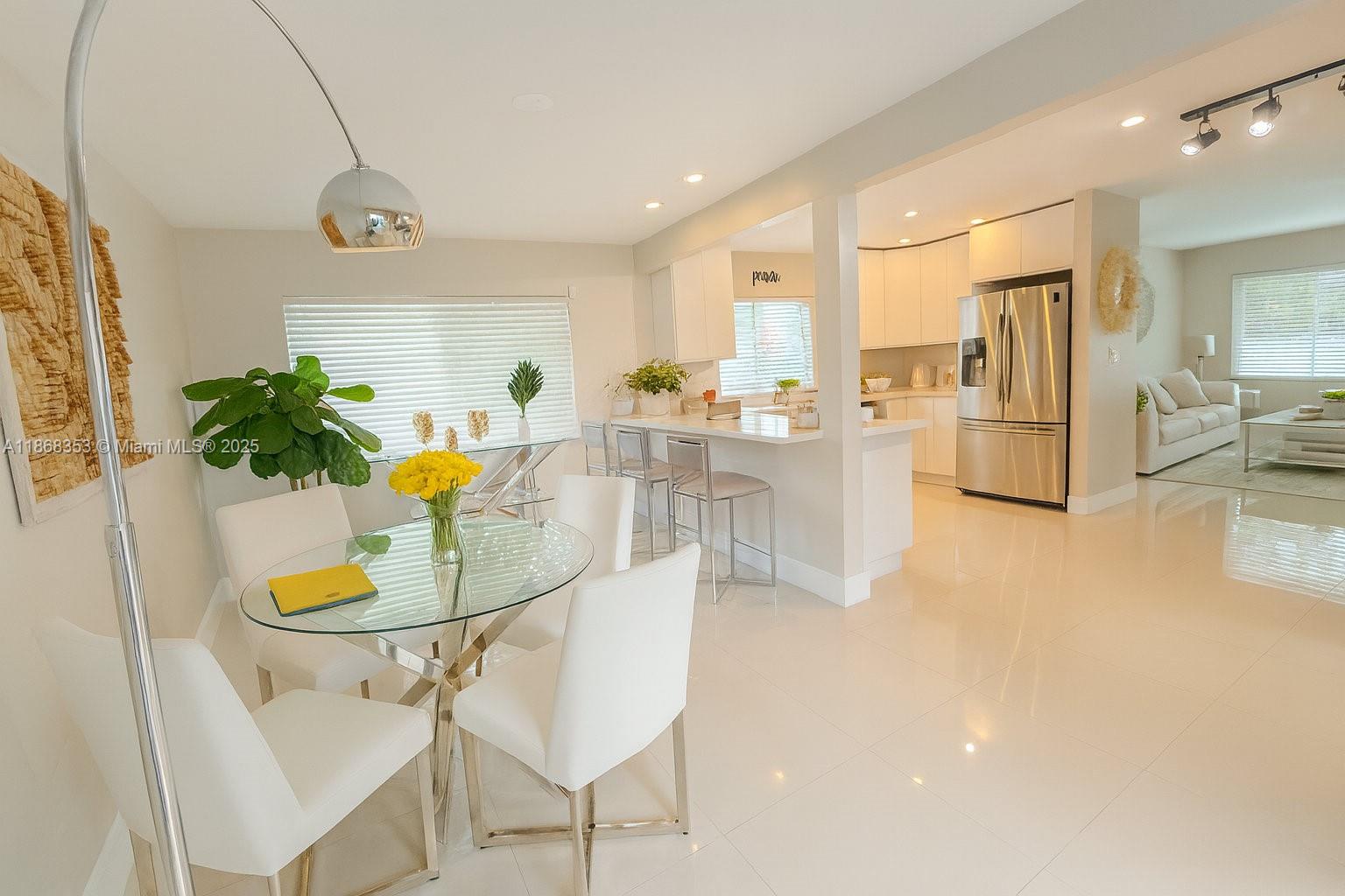 5250 Southwest 96th Avenue Miami, FL 33165 - Photo 8 of 16 a kitchen with stainless steel appliances kitchen island granite countertop a table and chairs in it