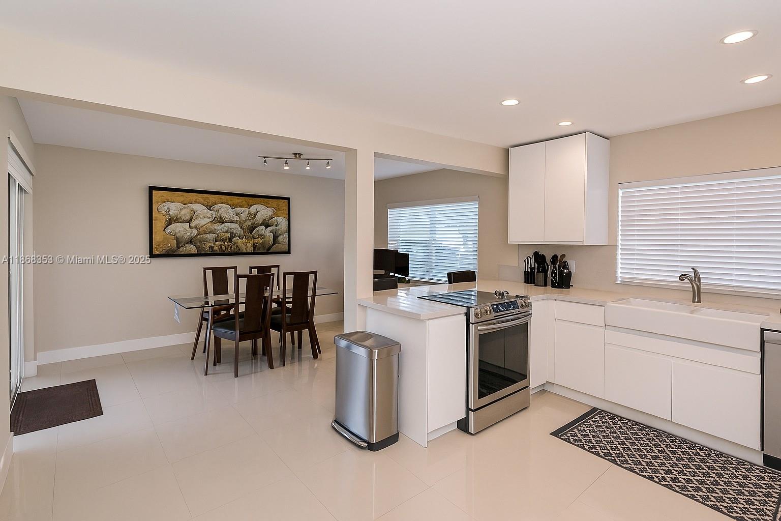 5250 Southwest 96th Avenue Miami, FL 33165 - Photo 10 of 16 a kitchen with a sink and a stove top oven