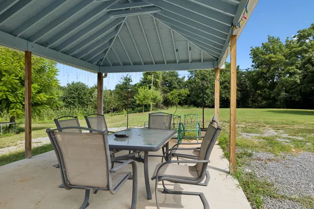 a view of outdoor space with green field and trees