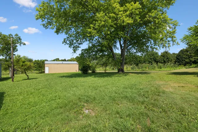 a living room with lots of furniture and a large window