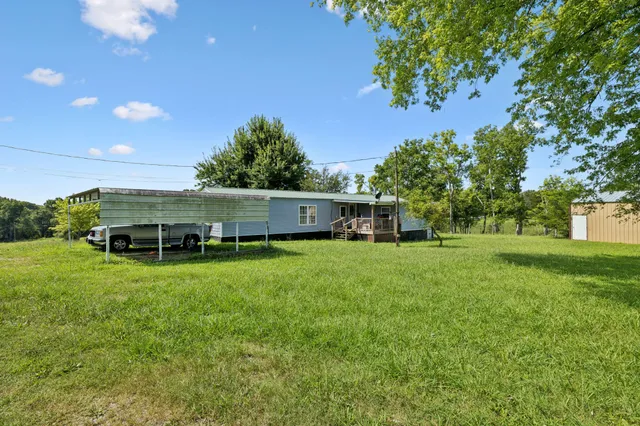 a kitchen with stainless steel appliances granite countertop a refrigerator a oven a sink with a dining table and chairs