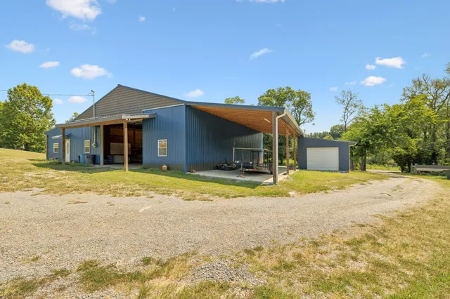 a front view of a house with a yard and a garage