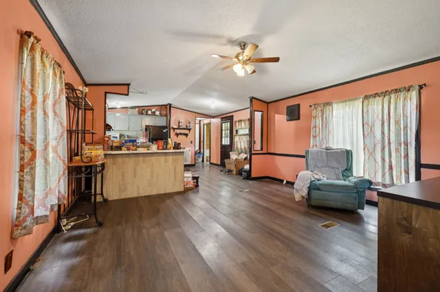 a kitchen with stainless steel appliances a refrigerator and wooden floor