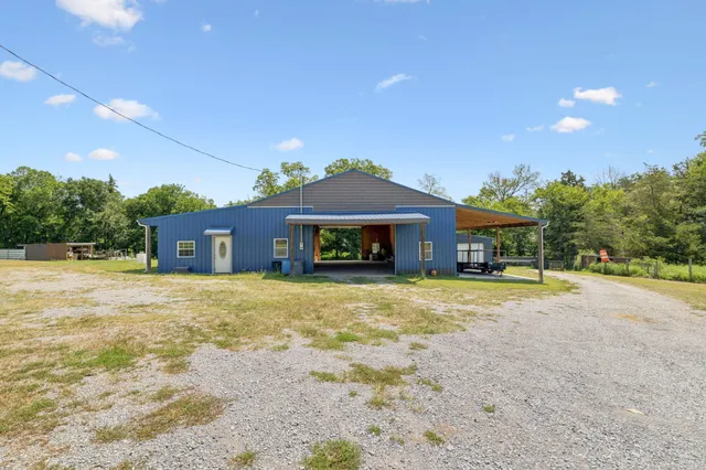 a view of a swimming pool with a patio and a yard