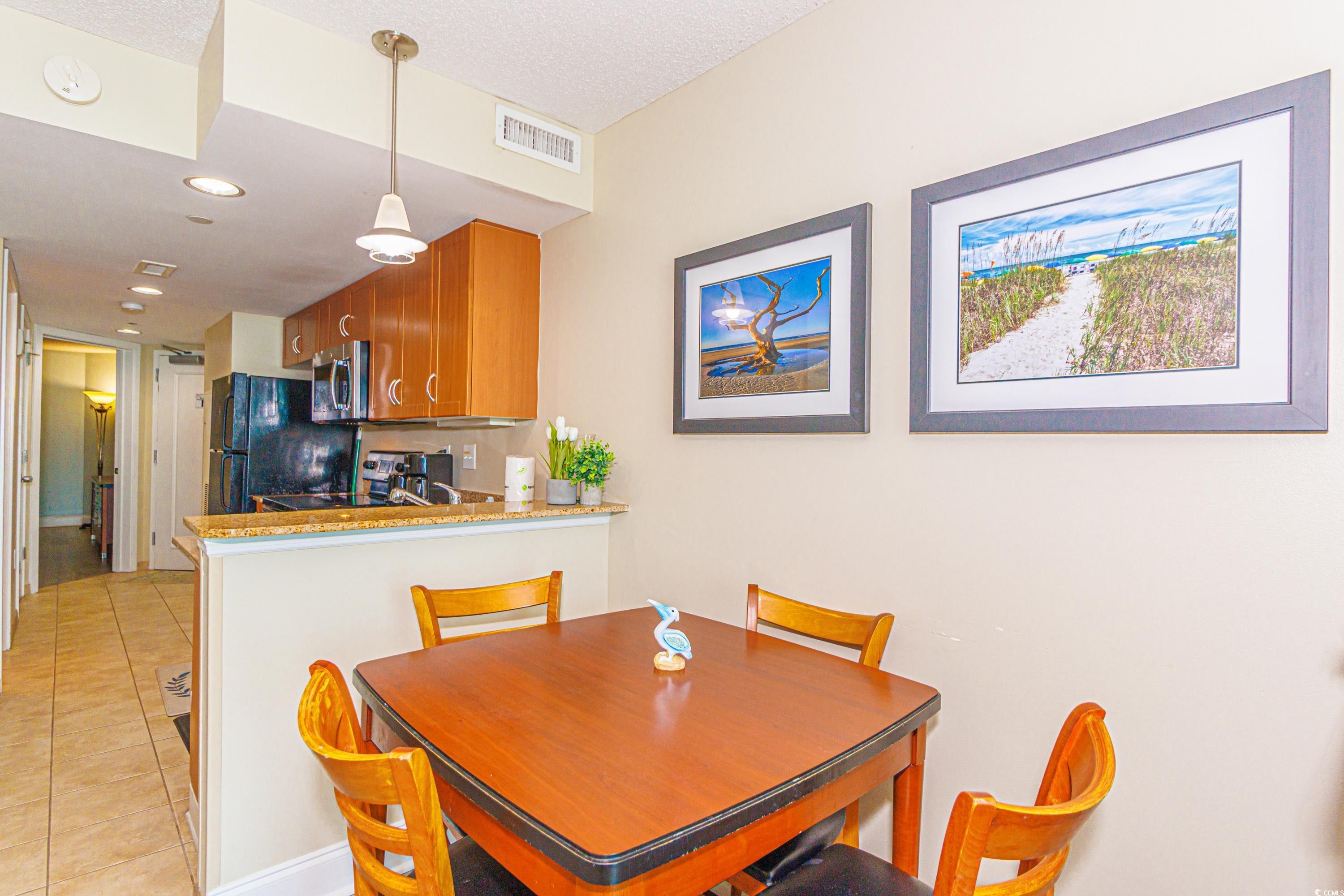 201 South Ocean Boulevard, Unit 1610 Myrtle Beach, SC 29577 - Photo 11 of 40 Dining room featuring light tile patterned floors, recessed lighting, and a textured ceiling