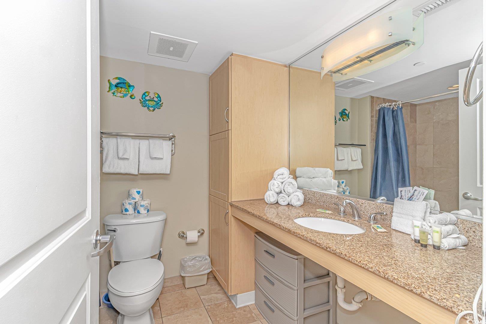 201 South Ocean Boulevard, Unit 1610 Myrtle Beach, SC 29577 - Photo 21 of 40 Full bathroom with vanity, light tile patterned floors, and curtained shower