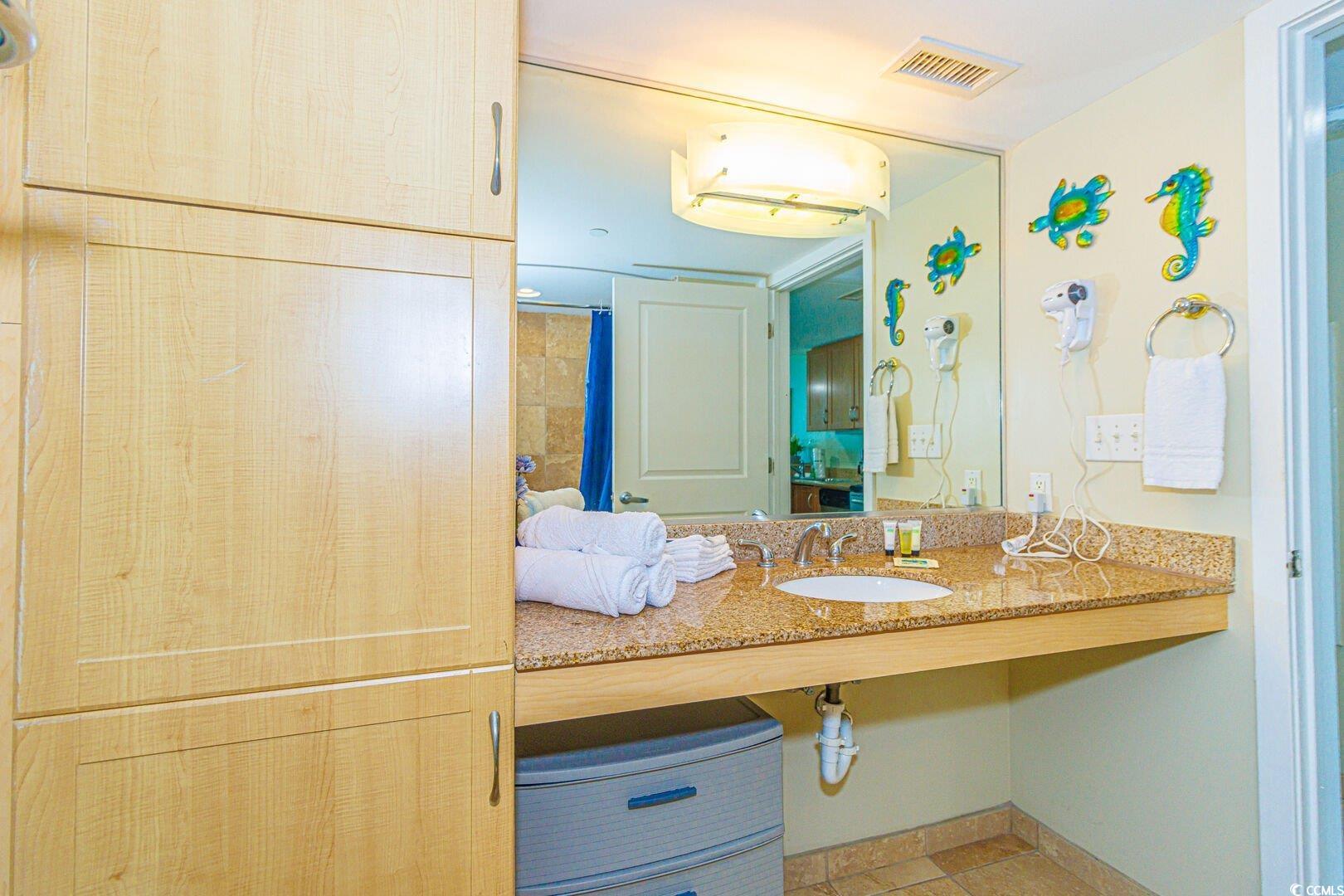 201 South Ocean Boulevard, Unit 1610 Myrtle Beach, SC 29577 - Photo 23 of 40 Bathroom featuring vanity, curtained shower, and tile patterned floors