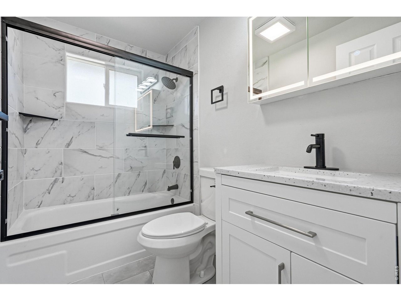 1035 6th Street Berthoud, CO 80513 - Photo 21 of 37 a bathroom with a shower a toilet and a sink