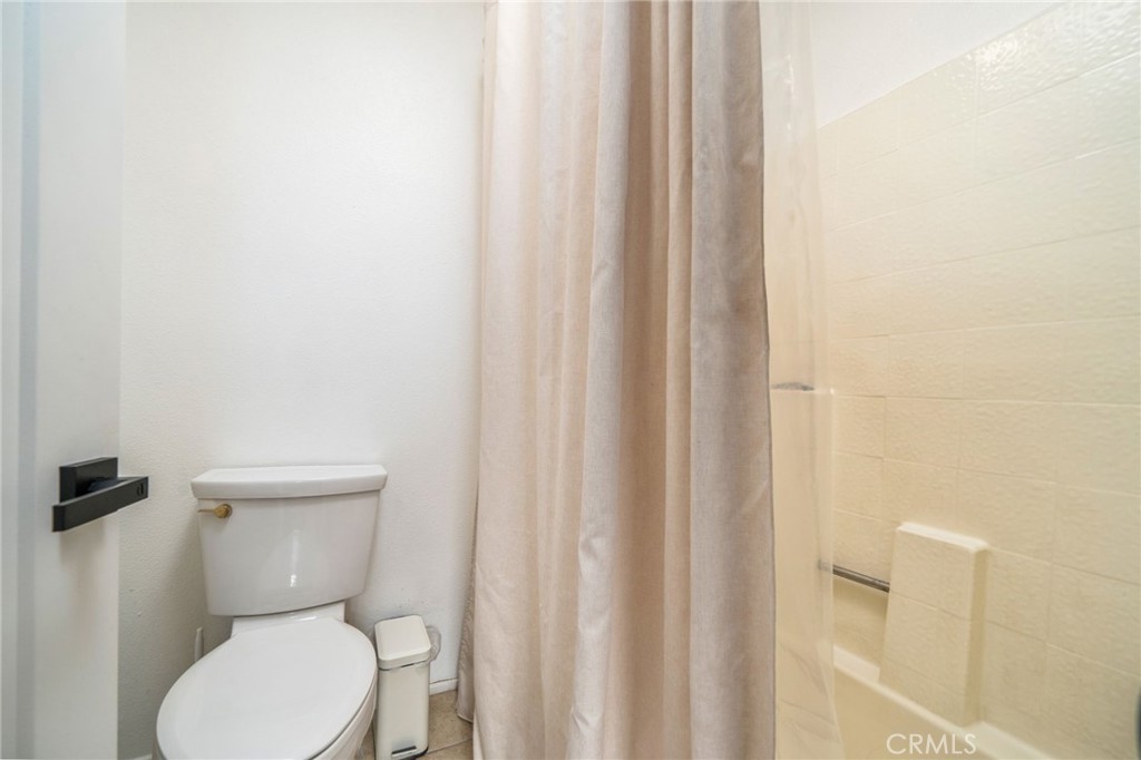 6870 Saddleback Place Rancho Cucamonga, CA 91701 - Photo 15 of 33 a white toilet sitting next to a shower