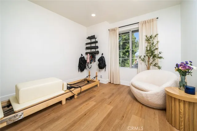 a living room with furniture a window and potted plants