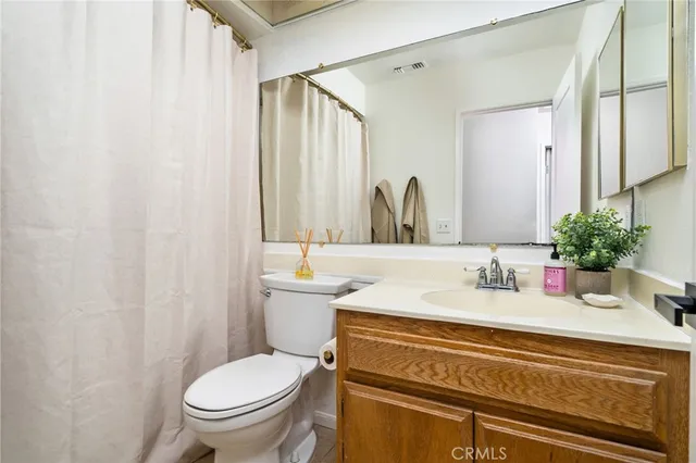 a bathroom with a sink toilet and mirror
