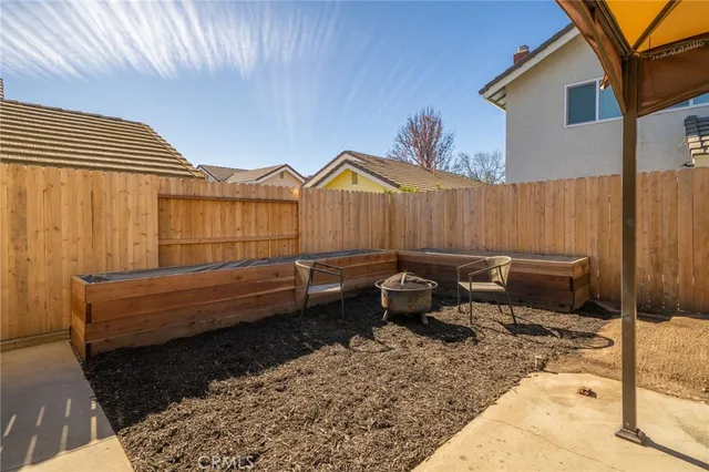 a backyard of a house with outdoor seating