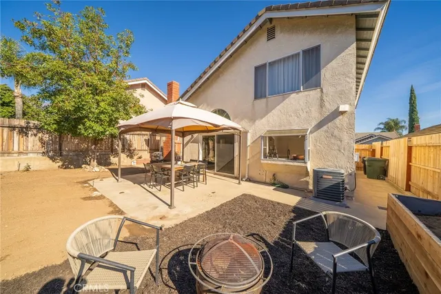 a view of a patio with table and chairs with wooden floor and fence
