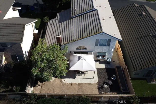 an aerial view of a house with balcony and outdoor space