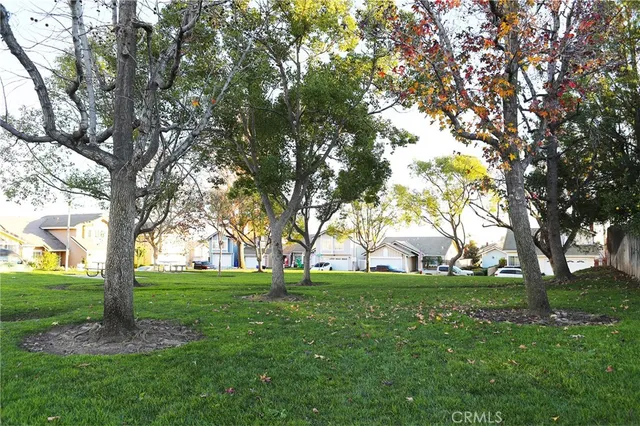 an aerial view of a residential houses with outdoor space and street view