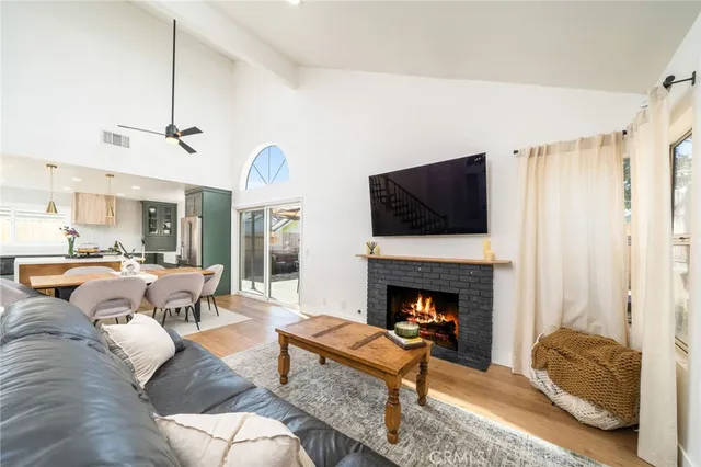 a living room with furniture fireplace and flat screen tv