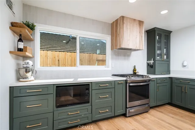 a kitchen with stainless steel appliances granite countertop a stove and a sink