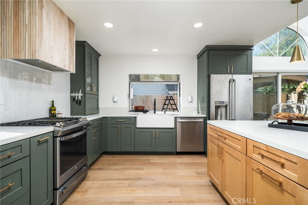 6870 Saddleback Place Rancho Cucamonga, CA 91701 - Photo 10 of 33 a kitchen with stainless steel appliances granite countertop a stove a sink and a refrigerator