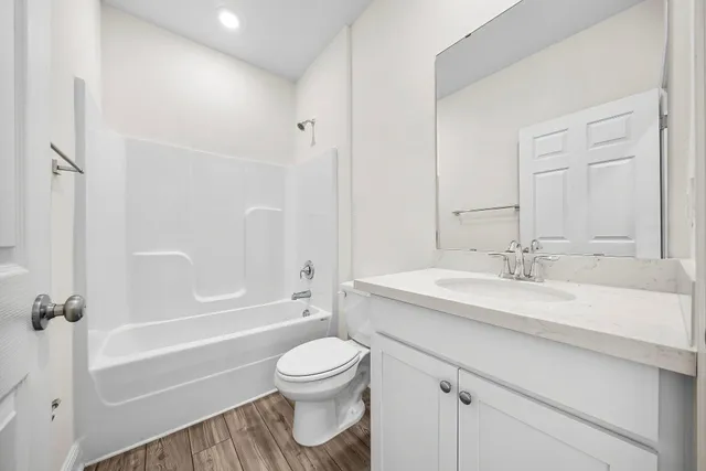 a bathroom with a sink a toilet and a bathtub