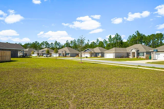 a house view with swimming pool and trees in the background