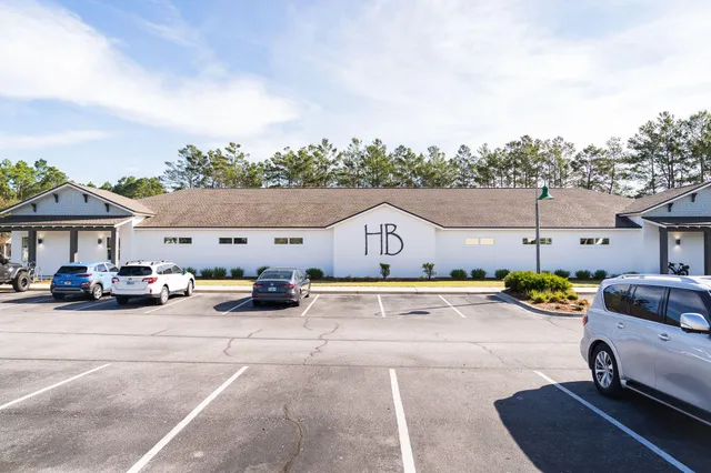a view of swimming pool with a yard and large tree