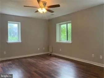 a view of a room with wooden floor and windows