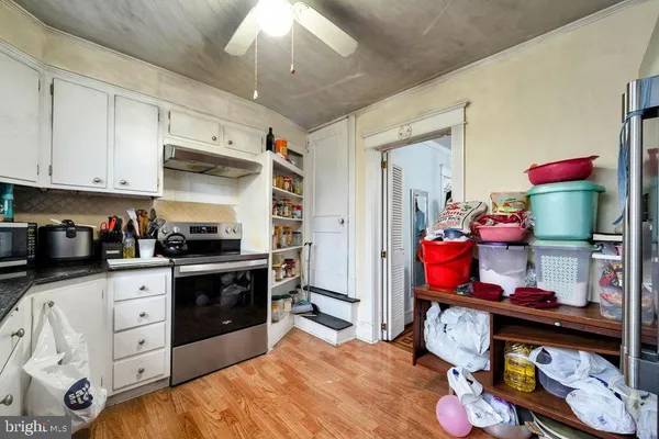 a kitchen with stainless steel appliances kitchen island granite countertop a sink dishwasher stove and cabinets