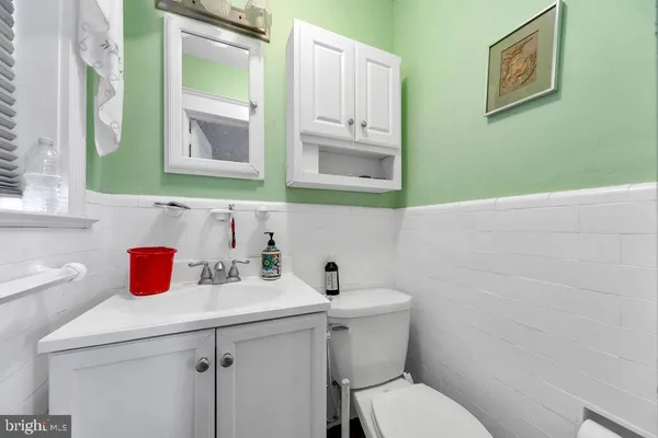 a bathroom with a toilet sink and mirror