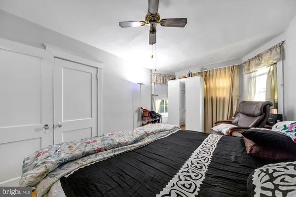 a bedroom with a bed chandelier and a window