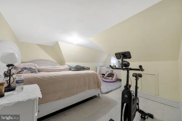 a bedroom with a bed and gym equipment