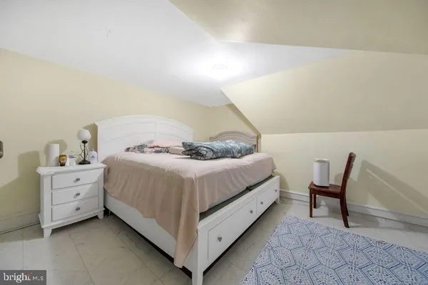 a bed room with a bed and a chair