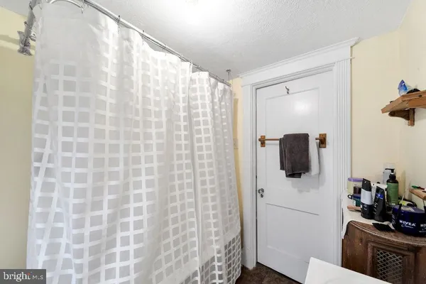 a bathroom with a shower and a sink
