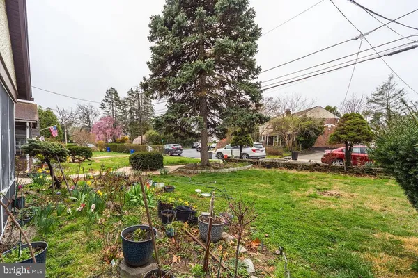 a view of a garden with a house