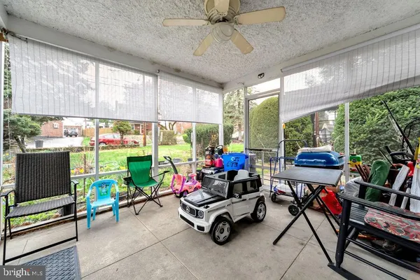 a living room with patio furniture and a floor to ceiling window