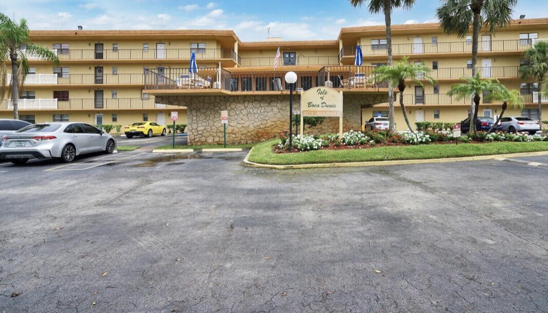 9273 Southwest 8th Street, Unit 209 Boca Raton, FL 33428 - Photo 1 of 8 a cars parked in front of a building