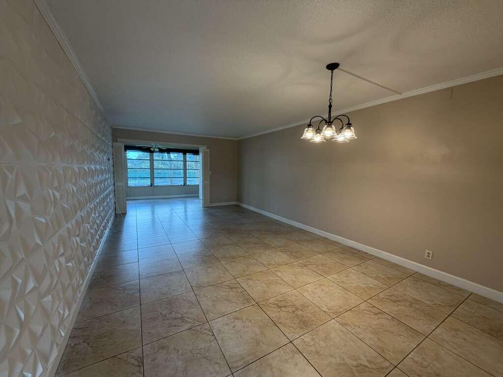 9273 Southwest 8th Street, Unit 209 Boca Raton, FL 33428 - Photo 6 of 9 a view of an empty room with a window