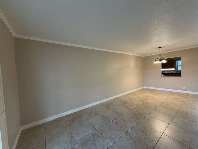 a view of a room with an empty space and a window