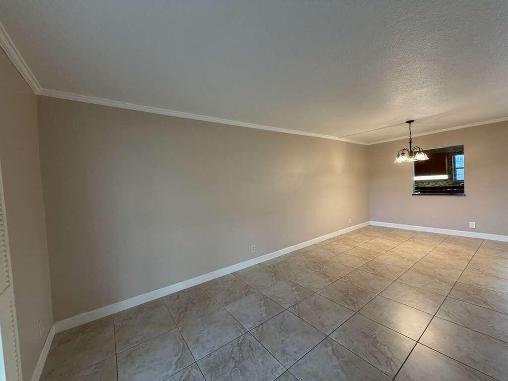 9273 Southwest 8th Street, Unit 209 Boca Raton, FL 33428 - Photo 7 of 9 a view of a room with an empty space and a window