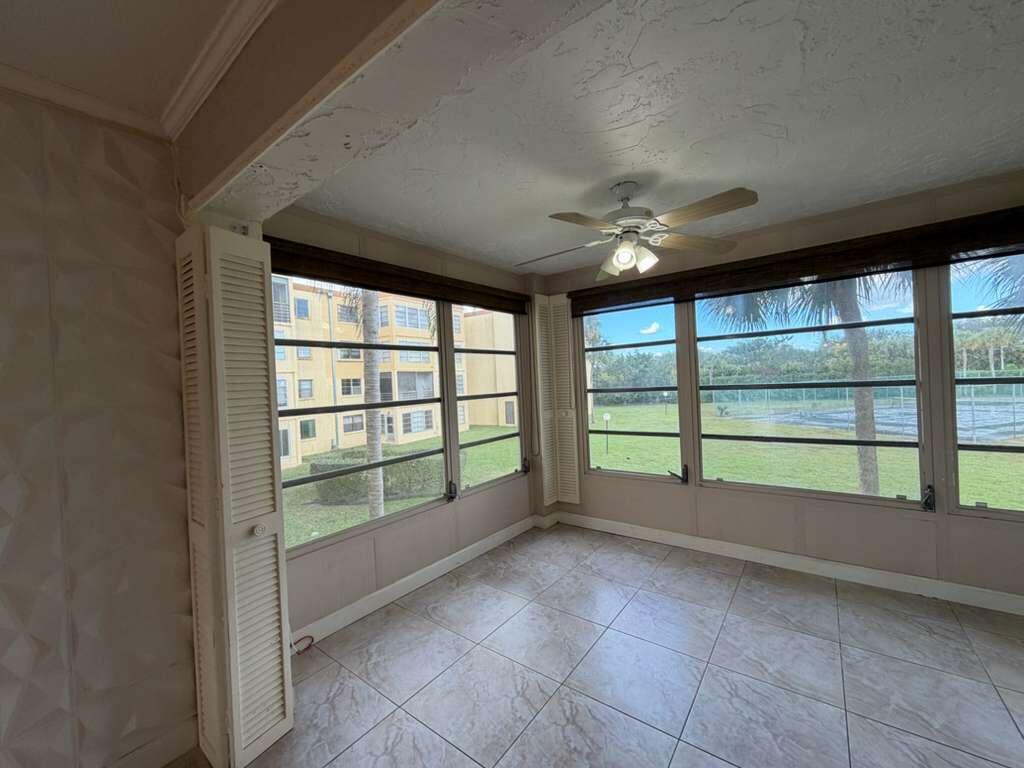 9273 Southwest 8th Street, Unit 209 Boca Raton, FL 33428 - Photo 8 of 9 a view of an empty room with a large window