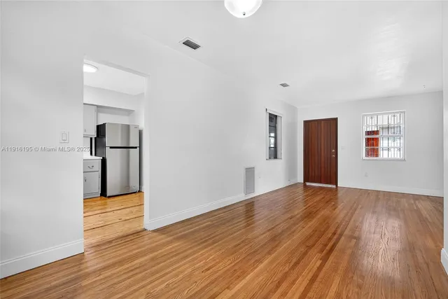 a kitchen with a sink a refrigerator and cabinets