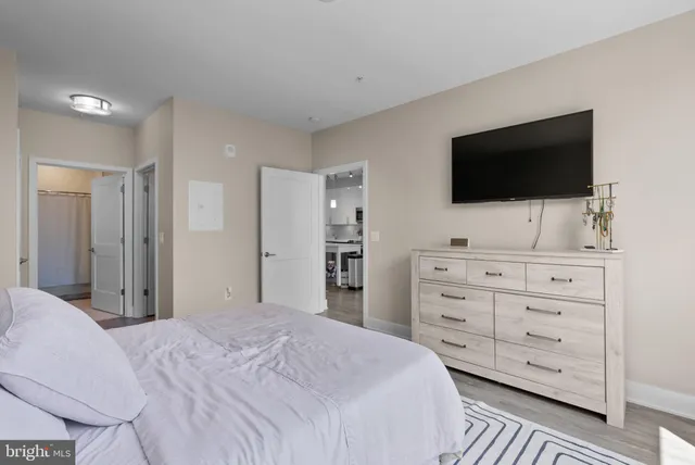 a bedroom with a large bed and a window