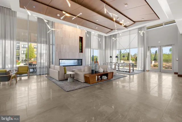 a living room with furniture a air conditioner vent and a large window